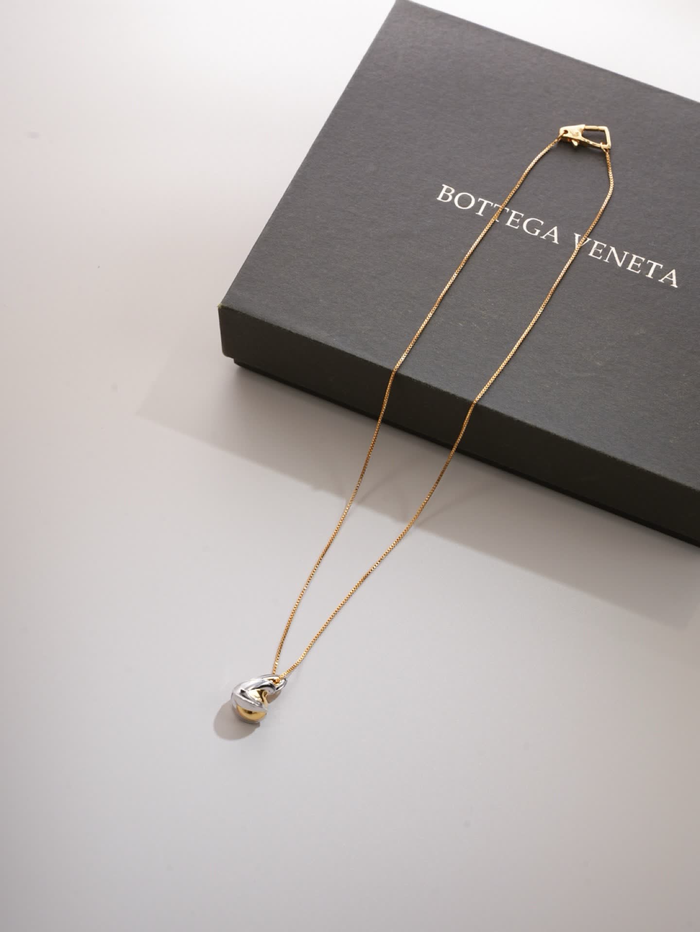 Bottega Veneta Elegant Gold and Silver Pendant Necklace